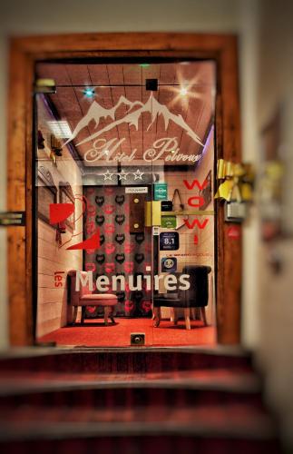 a window of a store with a bench in front at Hotel Le Pelvoux in Les Menuires