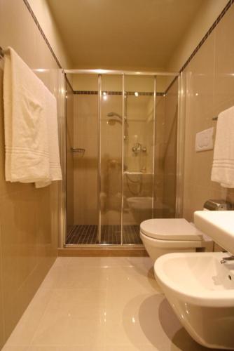 a bathroom with a shower and a toilet and a sink at Hotel GARDENIA & Villa CHARME Adults Friendly 4Star service in Bardolino