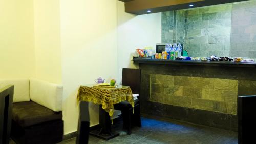 a room with a table and a counter with a table and a chair at NewCity Hotel & Suites in Cairo