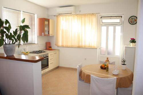 uma cozinha com uma mesa e uma sala de jantar em Apartment Anand em Dubrovnik