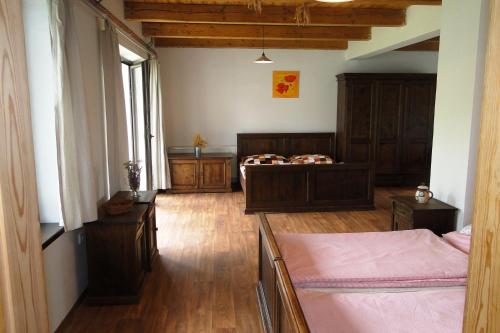 a bedroom with two beds in a room at Tradiční hostinec in Sněžné
