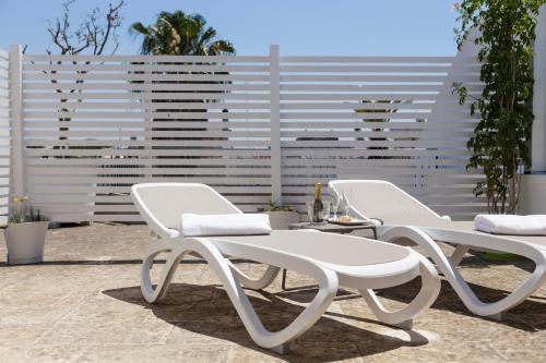 two white chairs and a table on a patio at Innsud in Nardò