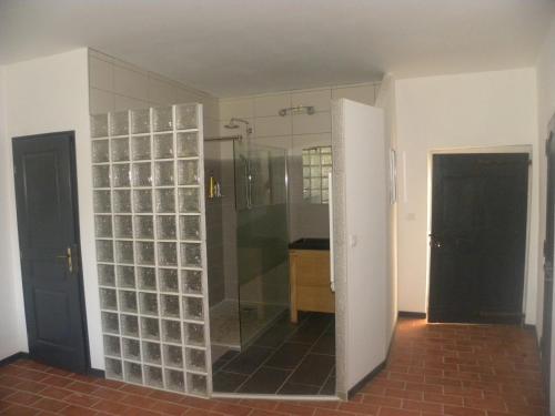 a bathroom with a shower and a glass wall at La Bastide Cévenole in Rochegude-Gard