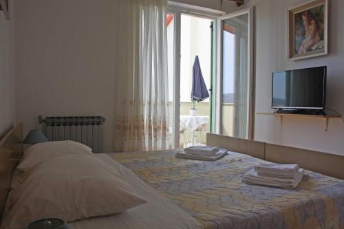 a bedroom with a bed with a mirror and a television at Branka Apartments in Labin