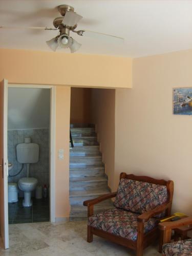 a living room with a couch and a staircase at Gouna's Aparts in Xi