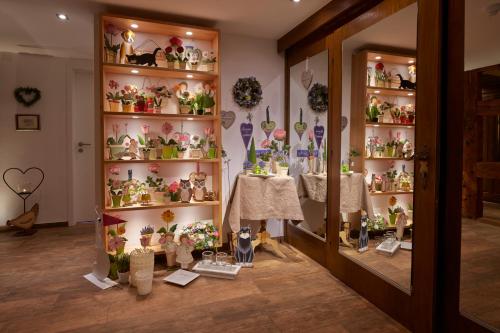 a room filled with shelves filled with lots of vases at Hotel Zum Ochsen in Schonwald im Schwarzwald