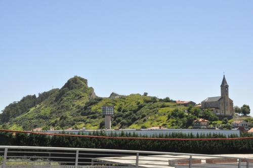 a hill in the distance with a mountain at Hotel San Millán in Santander