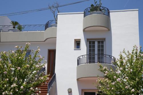 a white building with trees in front of it at Innsud in Nardò