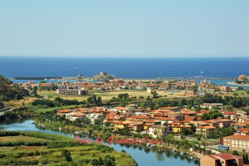 a small town next to a river at Casa vacanze Sandalia in Bosa