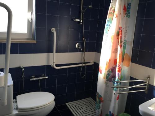 a bathroom with a toilet and a shower curtain at B&B Stella Marina in Manfredonia