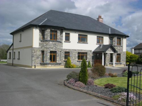 a white house with a black roof at Alverna House B&B in Athlone