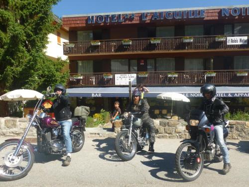 a group of people riding motorcycles in front of a building at Aiguille Noire in Valloire