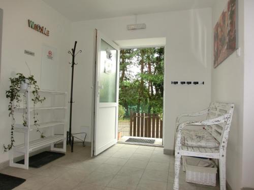 a room with an open door with a chair and a doorway at Pension Skalka in Liberec