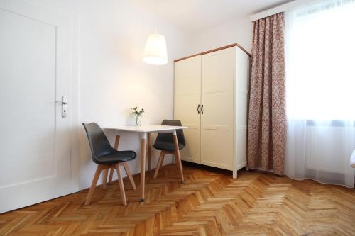 a dining room with a table and two chairs at Villa Gallistl in Český Krumlov