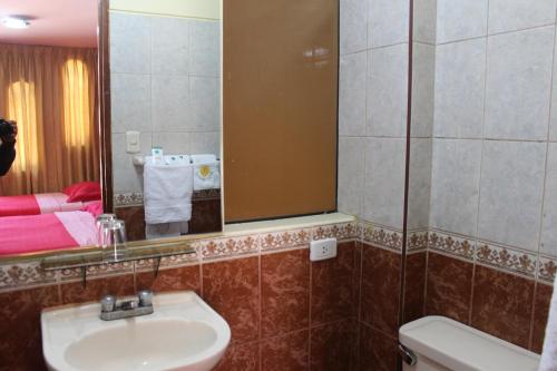 a bathroom with a sink and a mirror at Retamas Hotel in Cajamarca