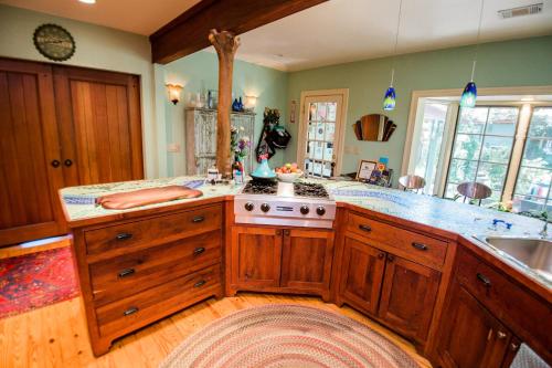 a large kitchen with wooden cabinets and a stove at Park Lane Guest House in Austin