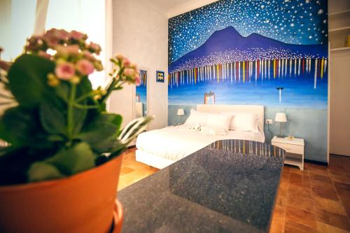 a bedroom with a bed and a painting of a mountain at NapoliMia Boutique Hotel in Naples