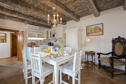 a kitchen and dining room with a white table and chairs at Residence U Mecenáše in Prague
