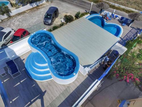 an overhead view of a water slide at a pool at Honeymoon Beach Studios in Perivolos