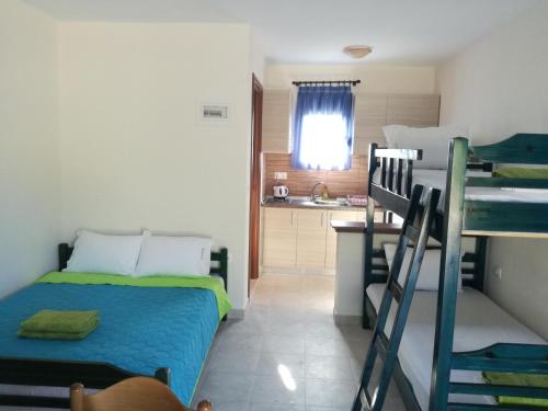 a small room with a bed and a kitchen at Pappou's Studios in Ormos Panagias