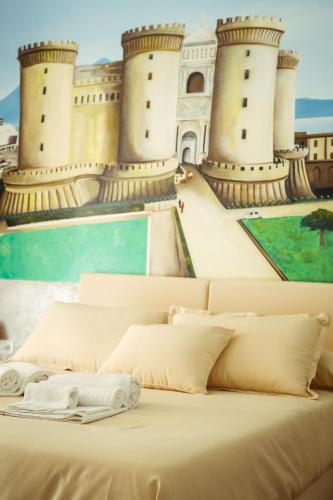 a bed with a view of a castle at NapoliMia Boutique Hotel in Naples