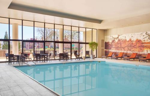a pool in a hotel with tables and chairs at Hyatt Regency Lexington in Lexington