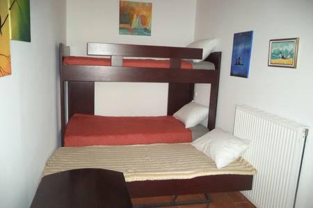 a bedroom with two bunk beds in a room at Kavousi Traditional Home in Falasarna