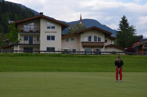 a man standing in the grass in front of a building at Green Apart in Uderns
