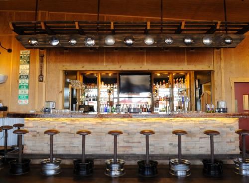 a bar with a bunch of stools in front of it at Royal Gorge Cabins in Buckskin Joe
