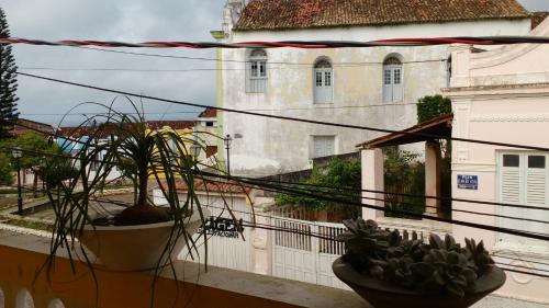 a balcony with two potted plants and a building at Agro Villa in Areia