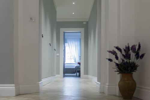 a hallway with a vase with a plant in it at AleMar Sirolo in Sirolo