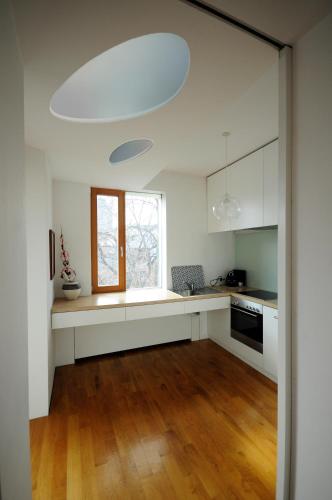 a kitchen with white cabinets and a window at Architectural City Loft in Sofia