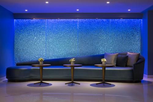 a blue couch in a room with two tables at Hotel Via in San Francisco