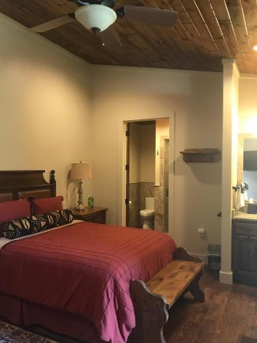 a bedroom with a bed and a wooden table at Joshua Creek Ranch in Boerne