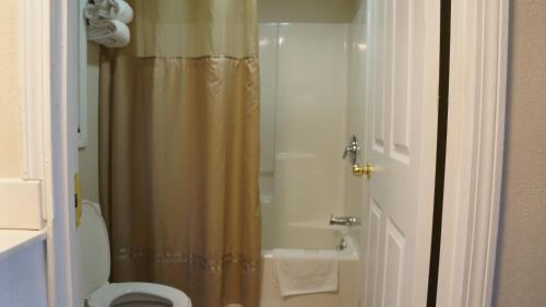 a bathroom with a toilet and a shower stall at Best Stay Inn in Plainville