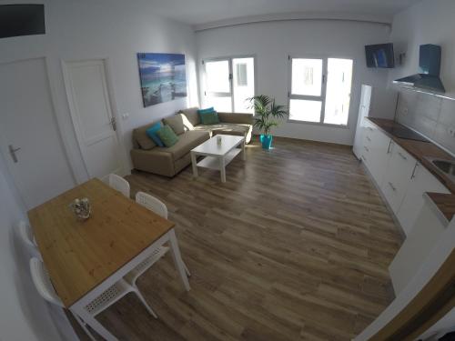 a living room with a table and a couch at Casa Playa Ondina in Gáldar