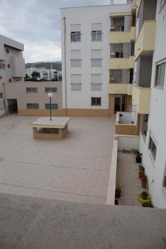 a large courtyard with a bench in the middle of a building at Your HOME, Nazaré in Nazaré