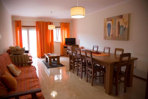 a living room with a table and chairs and a couch at Your HOME, Nazaré in Nazaré