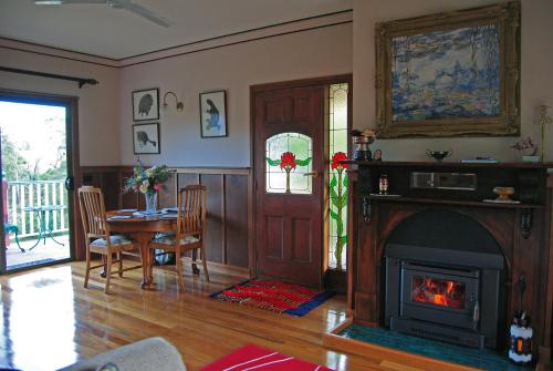 a living room filled with furniture and a fire place at Araluen Park Cottages in Lakes Entrance