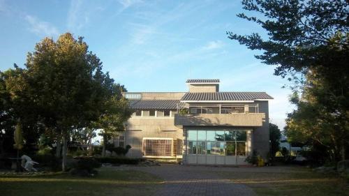 a large house with a roof on top of it at Tap Bed & Breakfast in Taitung City