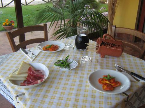 a table with plates of food on a table at B & B OASI in Rosciano