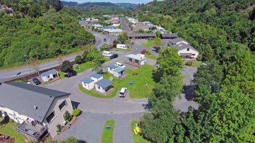 a street filled with lots of trees and houses at Leith Valley Holiday Park and Motels in Dunedin