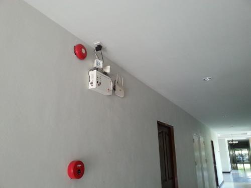 a white room with red objects on the wall at C.A.P Mansion in Phuket Town