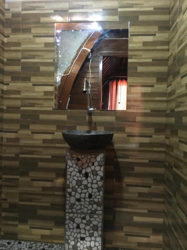 a bathroom with a sink and a mirror at Bamboo Bungalow Jungle View in Nusa Penida