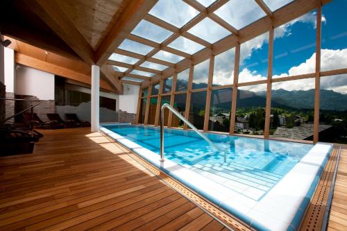 a swimming pool with a view of the mountains at Bohinj Eco Hotel in Bohinj