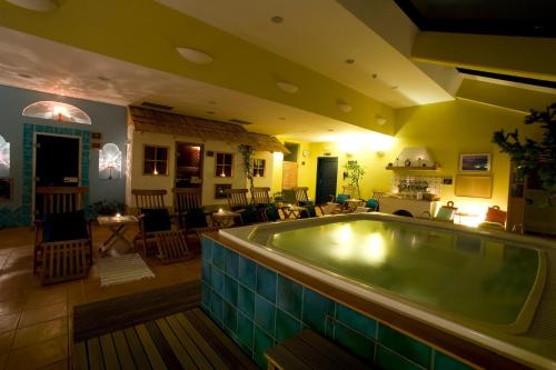 a large swimming pool in a room with a living room at Bohinj Eco Hotel in Bohinj