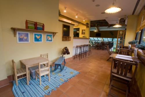 a room with a table and chairs and a bar at Bohinj Eco Hotel in Bohinj