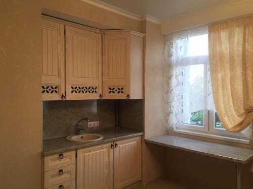 a kitchen with a sink and a window at Hotel Complex Mary in Orenburg