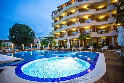 a hotel with a swimming pool in front of a building at Boutique Apart Hotel Versis in Sunny Beach