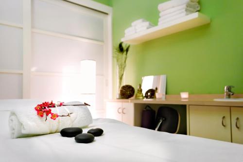 a bedroom with a white bed with black rocks on it at Dolce by Wyndham Bad Nauheim in Bad Nauheim